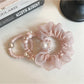 Pink mini scrunchie wrapped around a ponytail on a model's hair