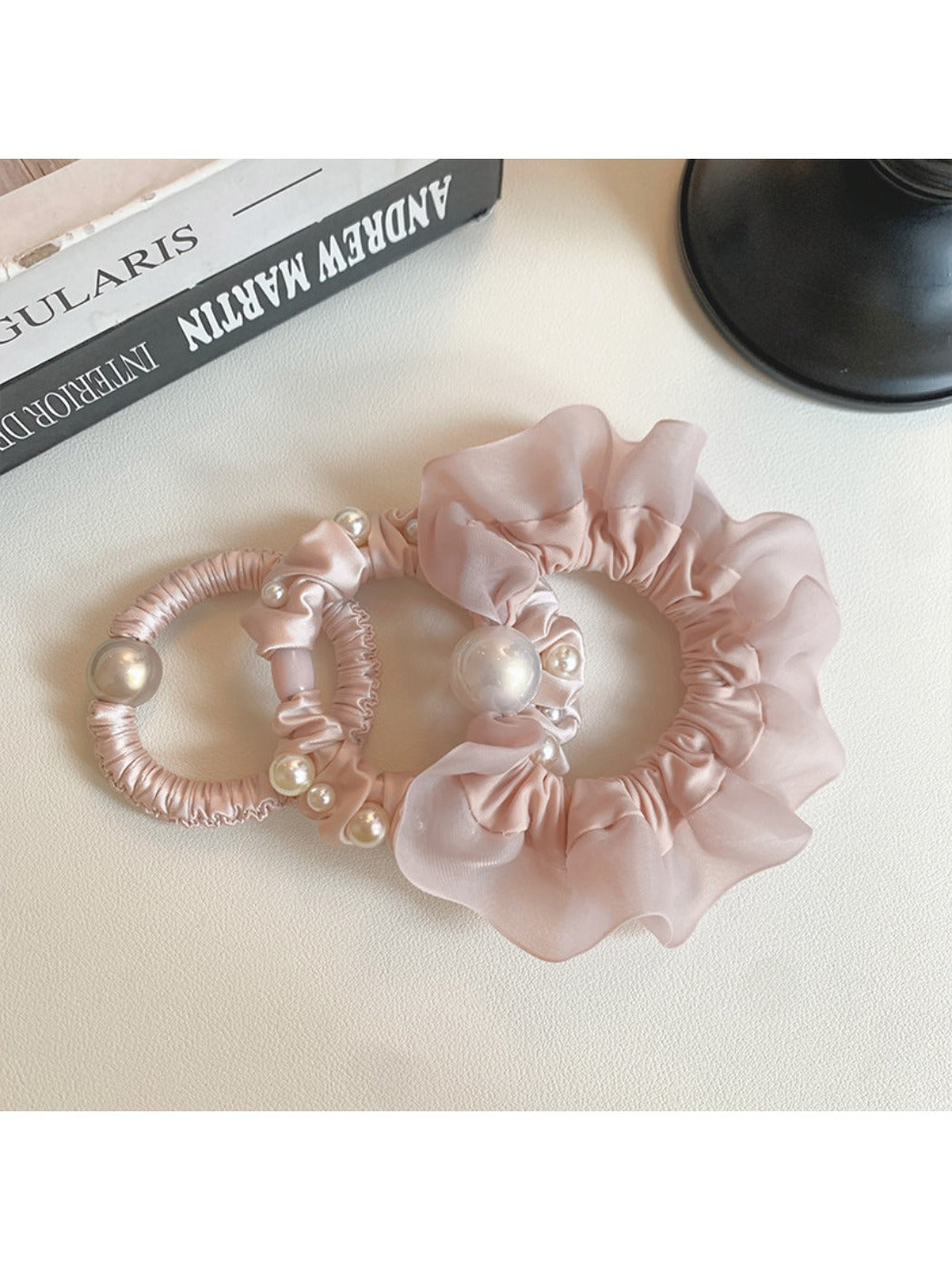 Pink mini scrunchie wrapped around a ponytail on a model's hair