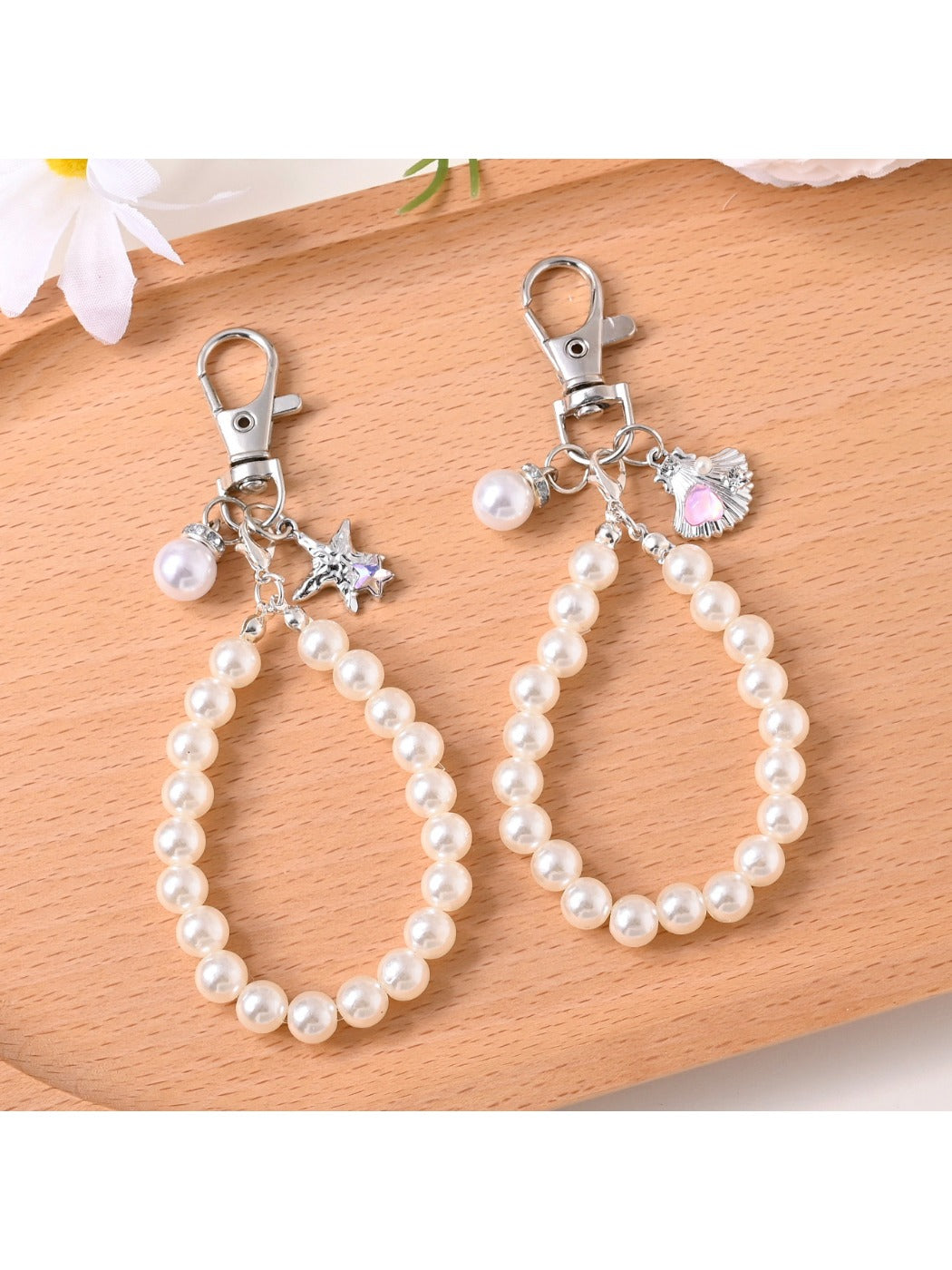 Keypus beaded bag charm keychain hanging from a beige handbag strap