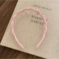 Gifty elegant wavy headband in pastel color displayed with soft lighting