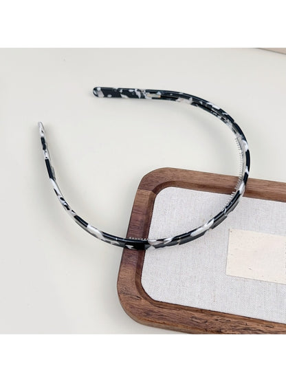 Side profile of Gifty acetate headband emphasizing silky smooth texture