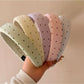 Side view of Gifty polka dot headband highlighting fabric texture