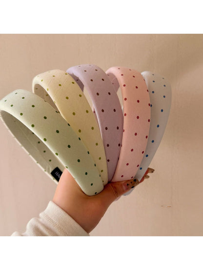 Side view of Gifty polka dot headband highlighting fabric texture
