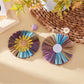 Pair of sunflower shaped earrings with yellow and brown color block design
