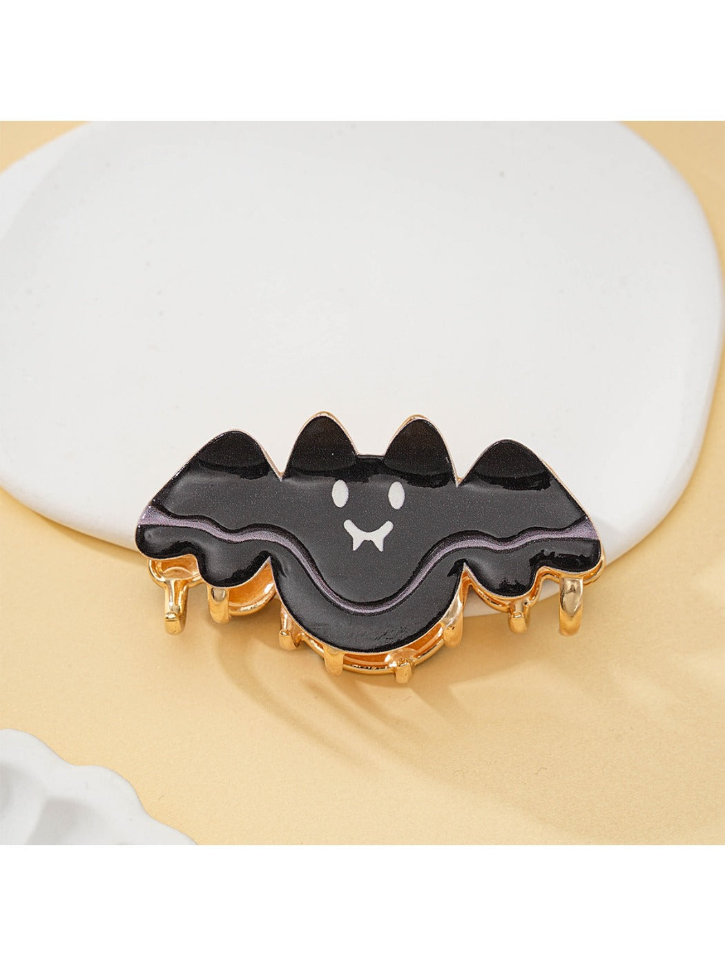 Close-up of Halloween bat hair clip showing textured wing design