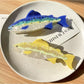 Beau salmon shaped hair claw clip held in hand to show size