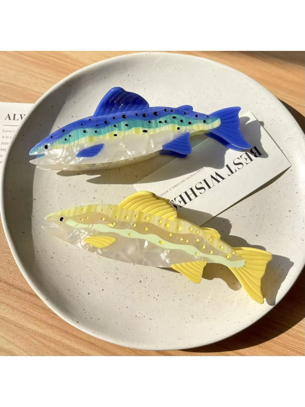 Beau salmon shaped hair claw clip held in hand to show size