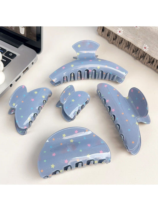 Blue star print hair claw clip with curved teeth on white background
