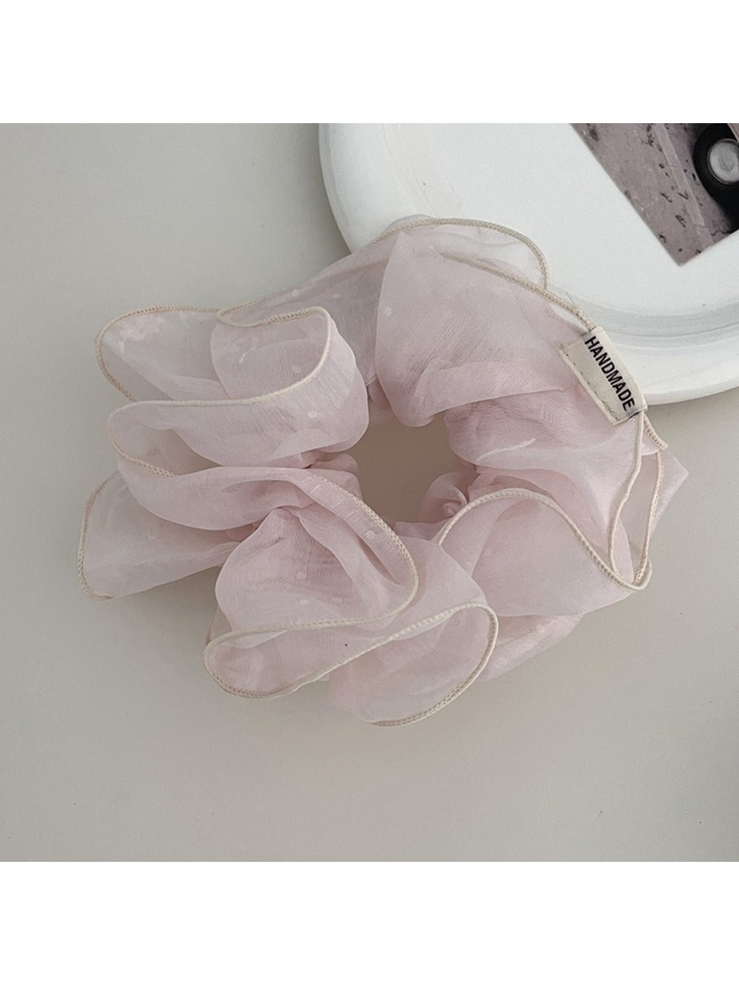Side view of Gifty ruffled scrunchie showing layered fabric texture