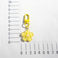 Flower keychain attached to a set of keys on a wooden surface