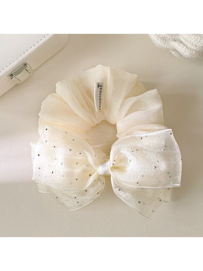 Model wearing large pink tulle bow scrunchie in hair
