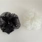 Gifty tulle scrunchie styled on a wrist with soft folds and sheer fabric