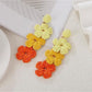 Earedge earrings laid flat showing detailed color block pattern and drop style