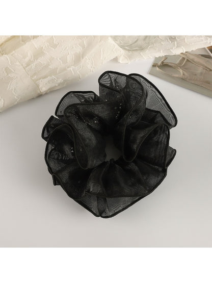 Gifty ruffled scrunchie worn on a wrist as a stylish accessory