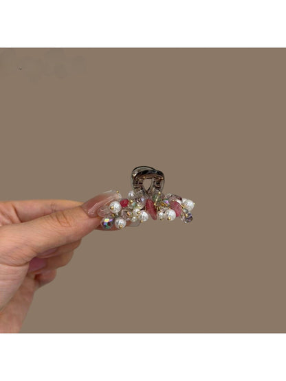 Beau hair clip clipped into blonde hair highlighting its vibrant colors and shape