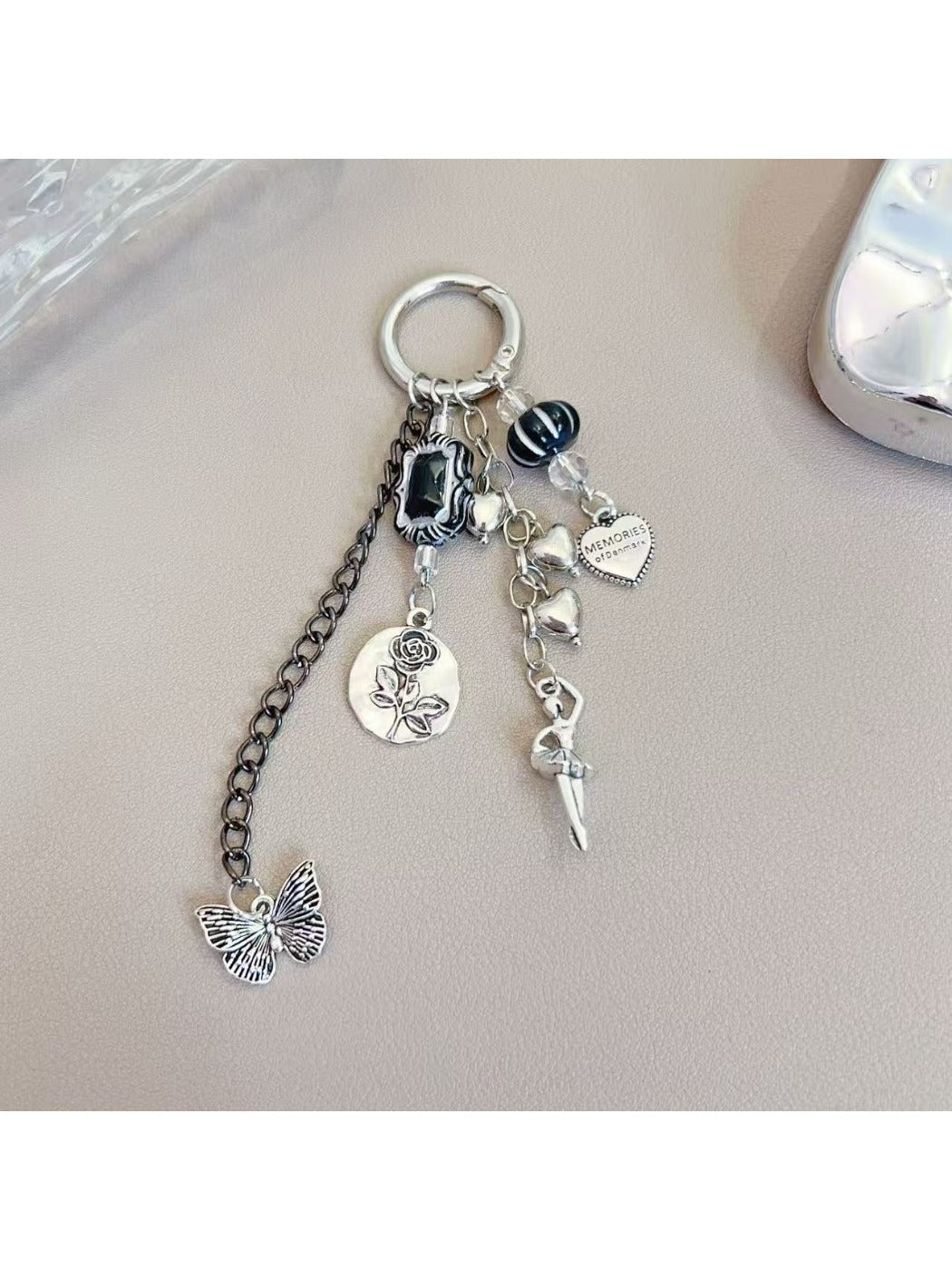Silver simple dancing girl charm keychain on a white background