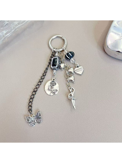 Silver simple dancing girl charm keychain on a white background