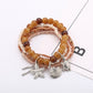 Lovra bracelet with multiple strands of small, round, colorful beads on a neutral surface