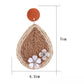 Side view of raffia woven teardrop earrings showing texture and weave detail