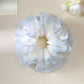 Gifty tulle ruffle scrunchie displayed on a white background highlighting its airy design
