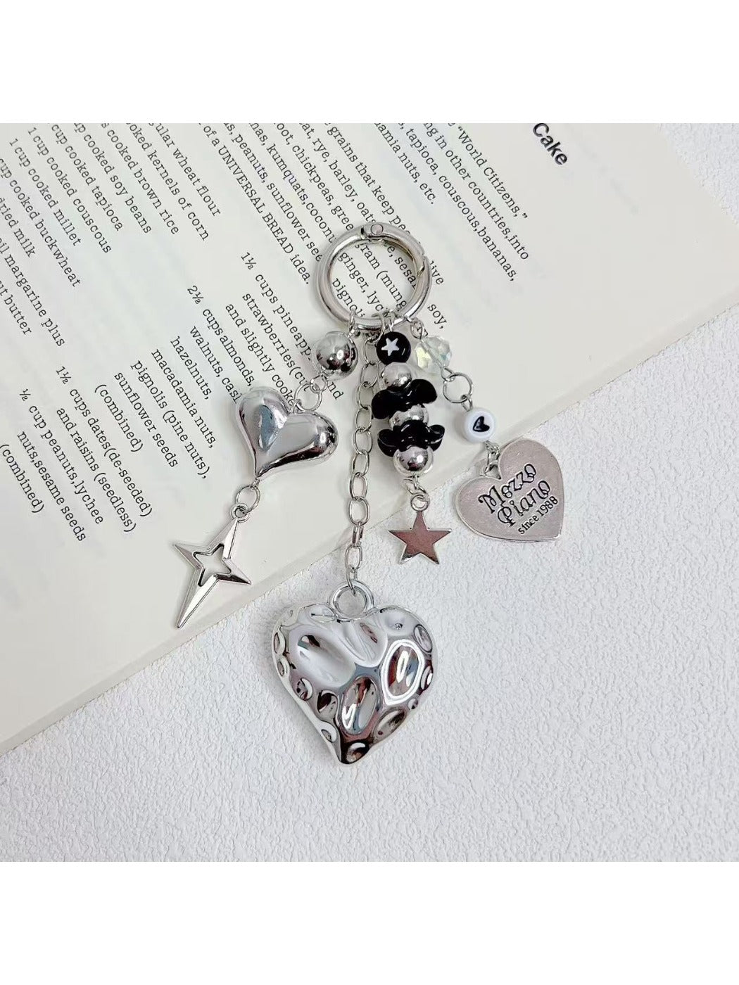 Close-up of silver heart charm on a minimalist keychain with a split ring
