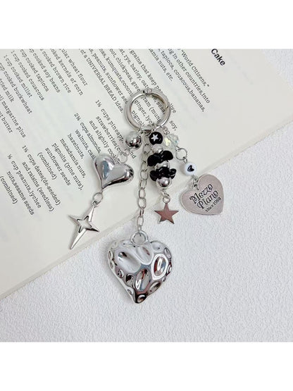 Close-up of silver heart charm on a minimalist keychain with a split ring