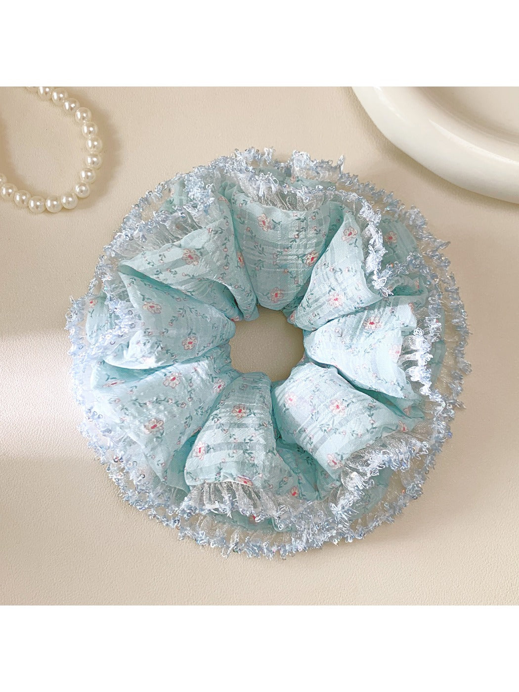 Double layer lake blue scrunchie with floral pattern on white background