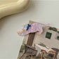 Beau cat hair clip clipped on a strand of blonde hair