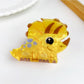 Orange fox shaped hair claw clip highlighting ears and facial features
