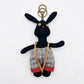 Fabric puppy keychain held in hand to show scale and detail