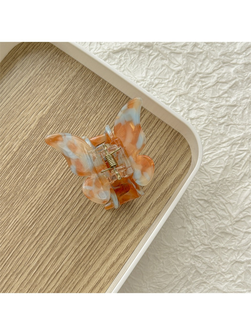 Beau butterfly claw clip with metal spring and plastic wings in light colors