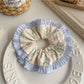 Gifty tiny floral print scrunchie styled in a casual hair bun