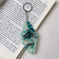 Diamond pendant keychain held in hand showing size and vibrant color details