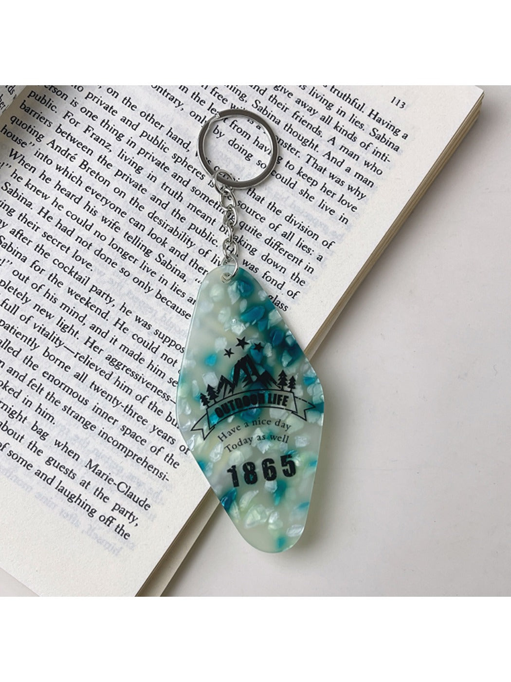 Diamond pendant keychain held in hand showing size and vibrant color details