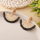 Close-up of earring hook and raffia fan detail on drop earrings