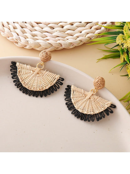 Close-up of earring hook and raffia fan detail on drop earrings