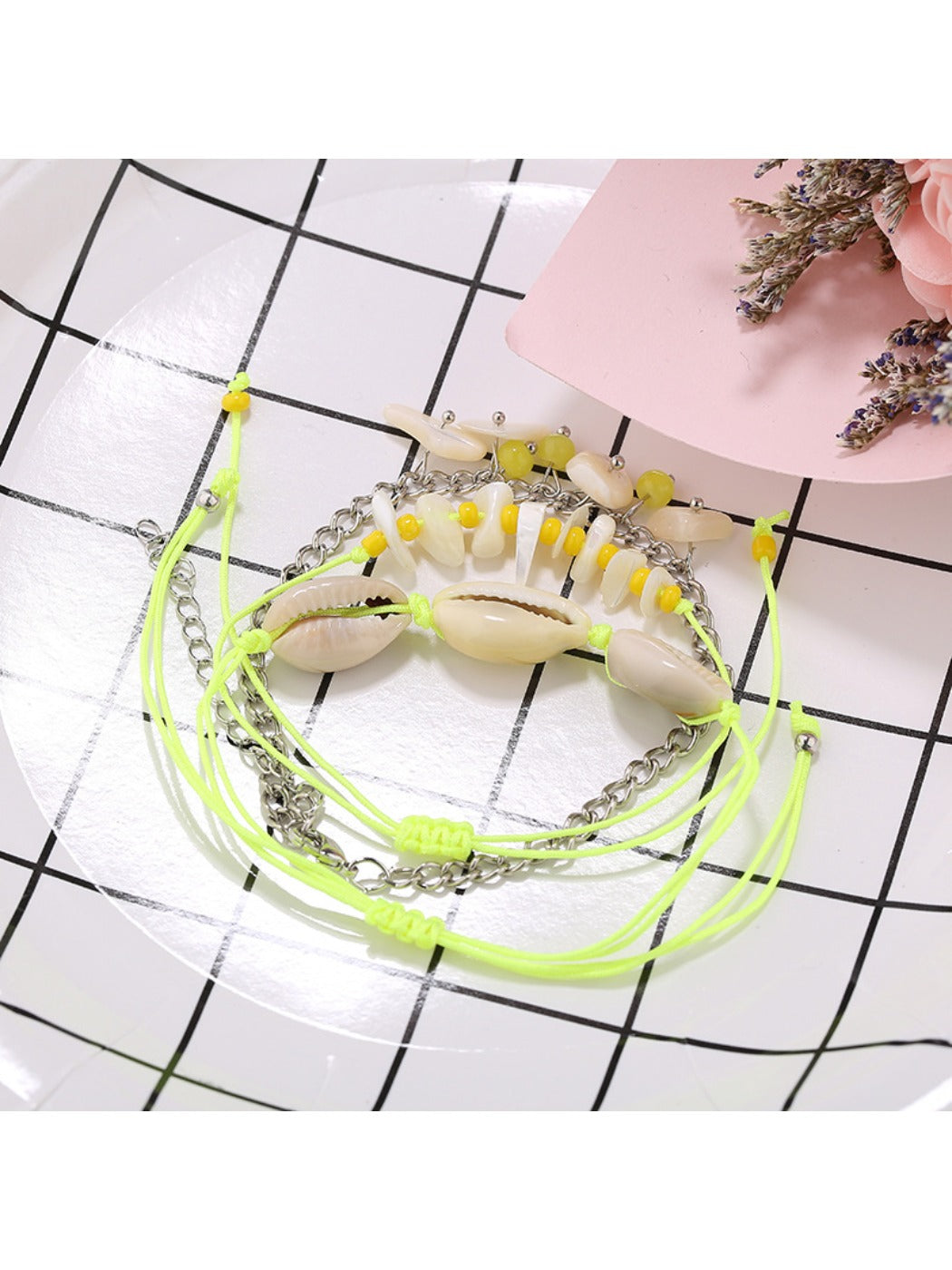 Model wearing Lovra beach style bracelet with layered bracelets on wrist