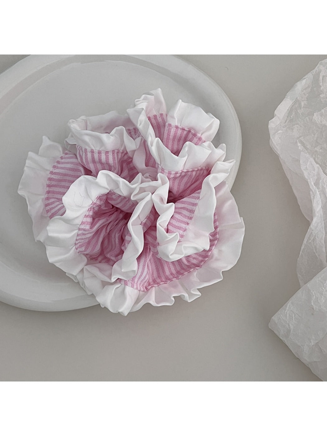Gifty Sweet Stripe Ruffle Scrunchie styled on a wrist with soft lighting