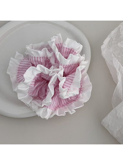 Gifty Sweet Stripe Ruffle Scrunchie styled on a wrist with soft lighting