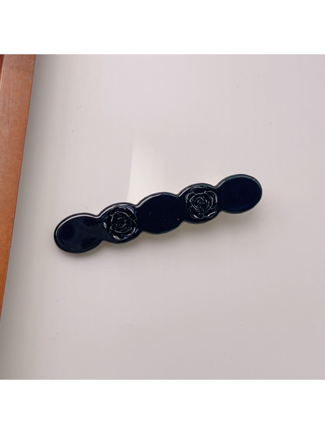 Beau rose decorated wavy hair clip packaged in clear box for retail