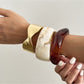 Close-up of Lovra vintage marble pattern wide bracelet showing smooth curved surface