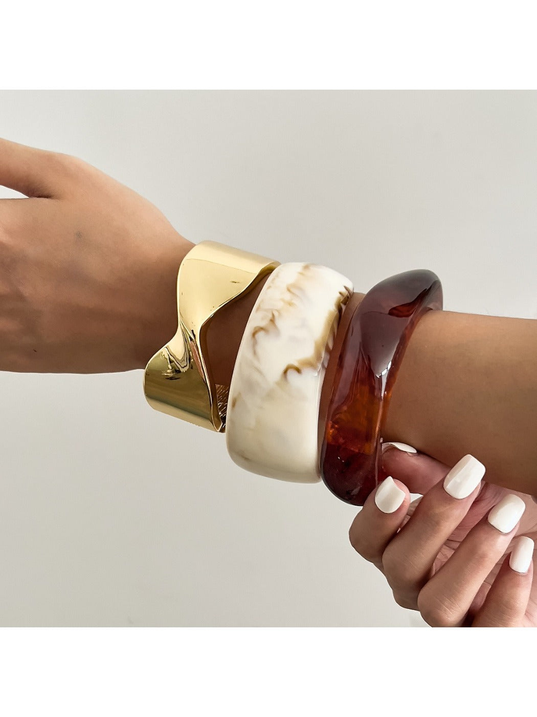 Close-up of Lovra vintage marble pattern wide bracelet showing smooth curved surface