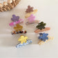 Close-up of Beau fresh acetate flower shaped hair clip in translucent pastel colors