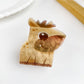 Beau bear shaped hair claw clip held in hand showing size and detail