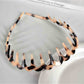 Gifty acetate headband worn on model with wavy toothed pattern