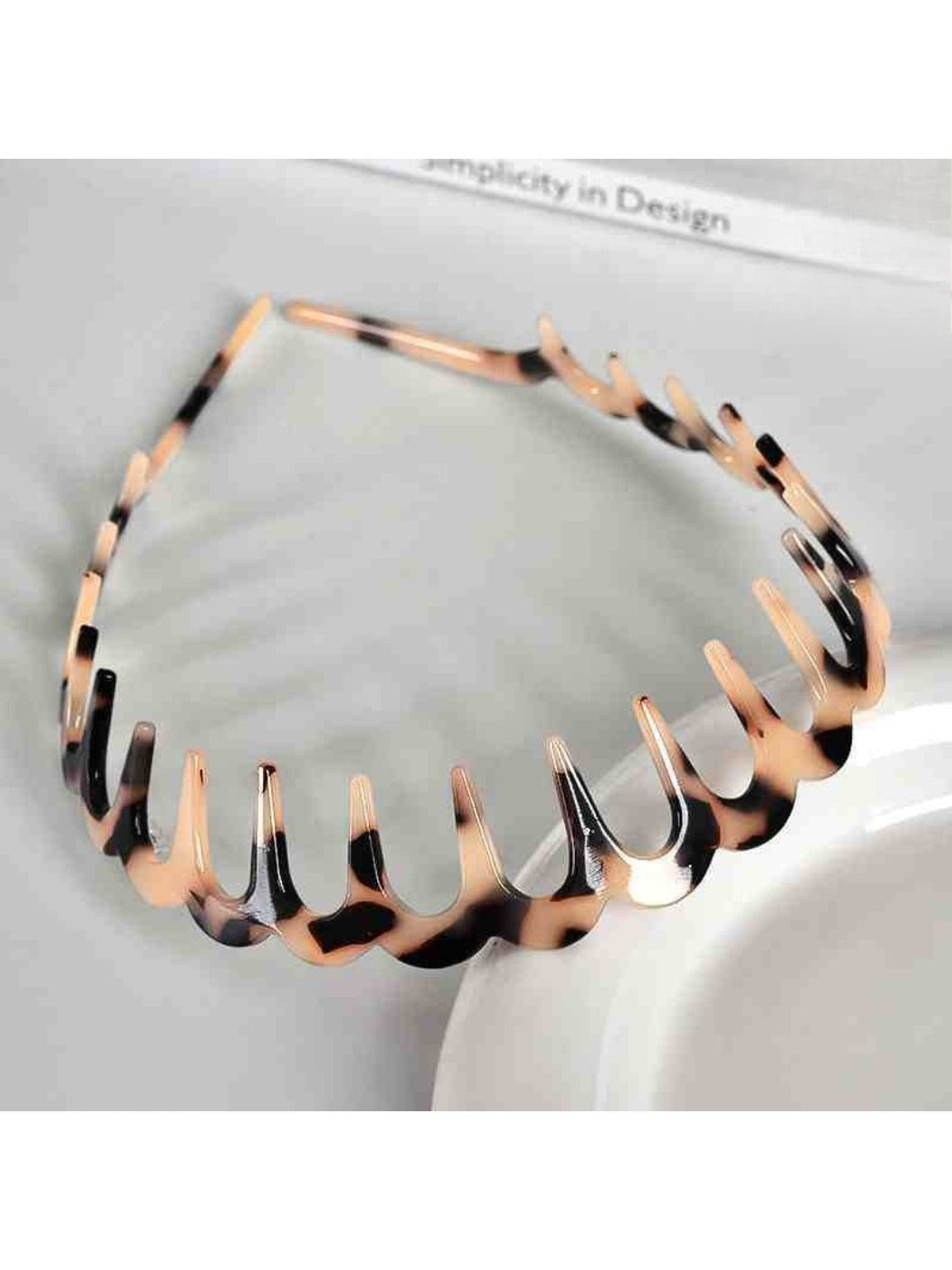 Gifty acetate headband worn on model with wavy toothed pattern