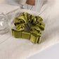 Romantic charm scrunchie styled with loose curls for a soft feminine look