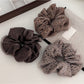 Close-up of Gifty leopard print tulle scrunchie with ruffled texture