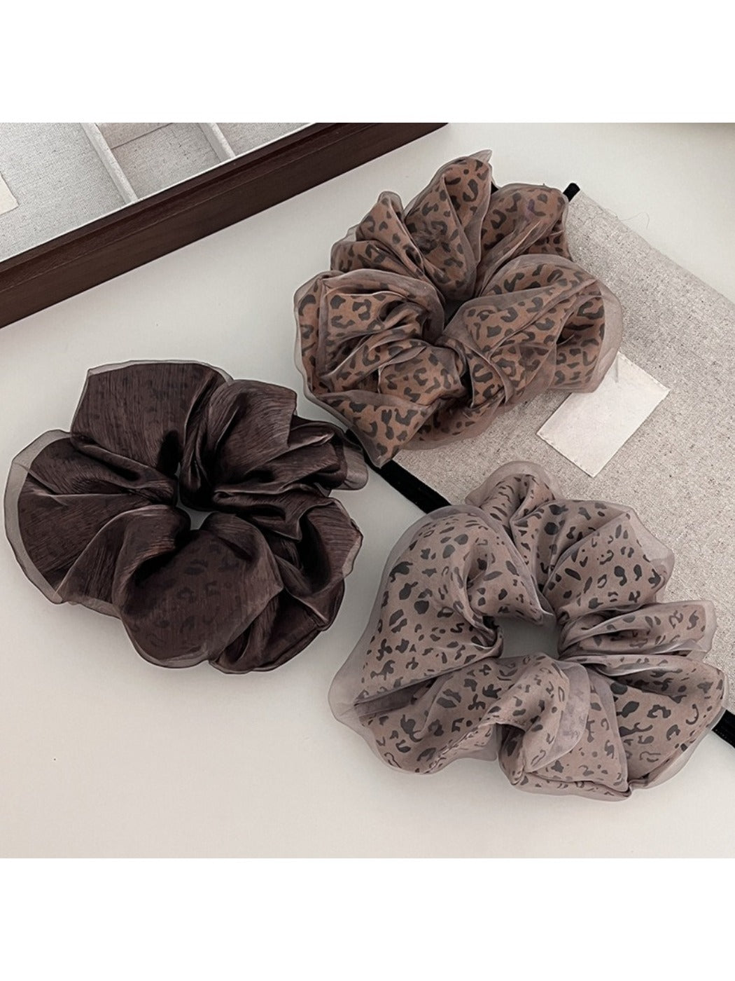 Close-up of Gifty leopard print tulle scrunchie with ruffled texture