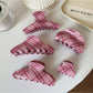 Close-up of Beau elegant pink plaid hair claw clip on white background